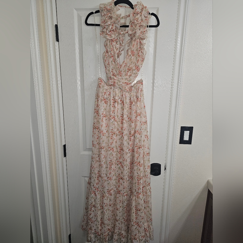 Stunning cutout ruffle sleeve floral maxi dress. Sexy side cut out and tie back.